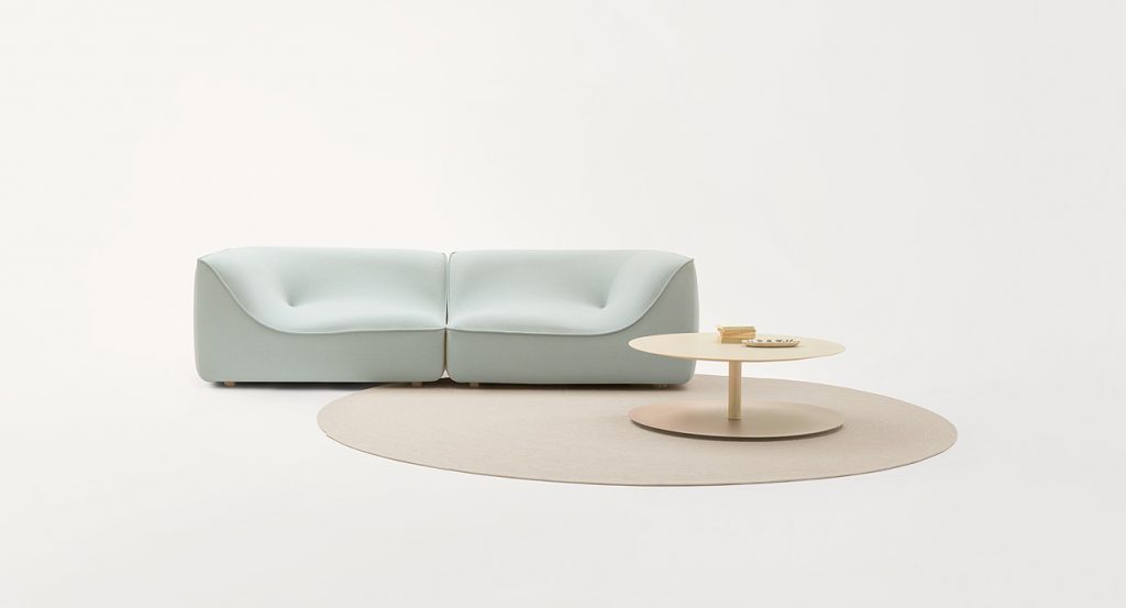 Blue So Sofa, two seater, fabrics upholstery, wood base in a living room.