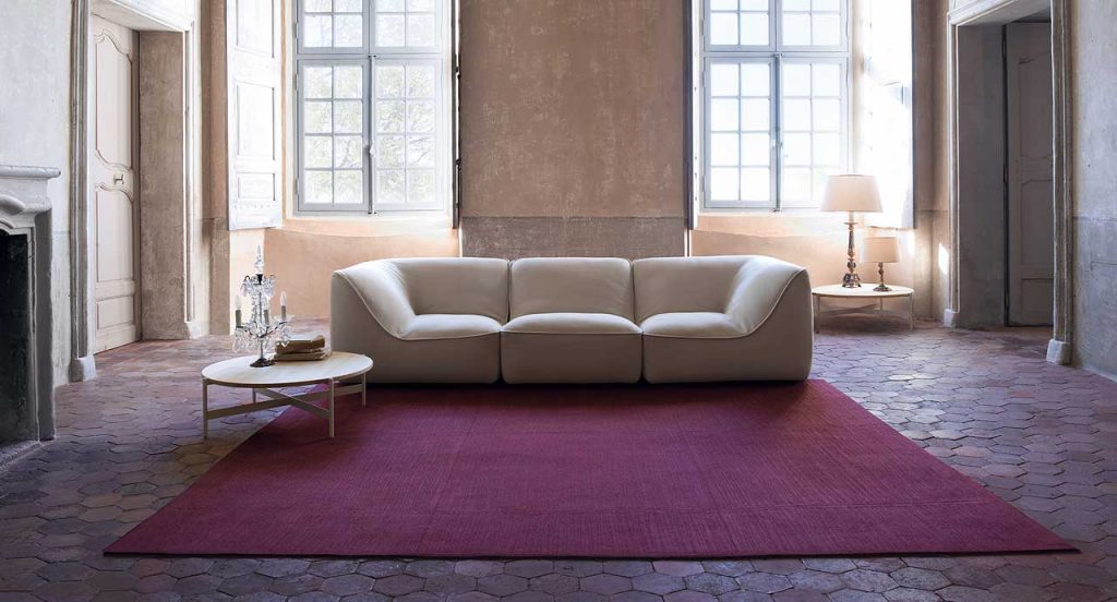 White So Sofa, three seater, fabrics upholstery, wood base in a living room.