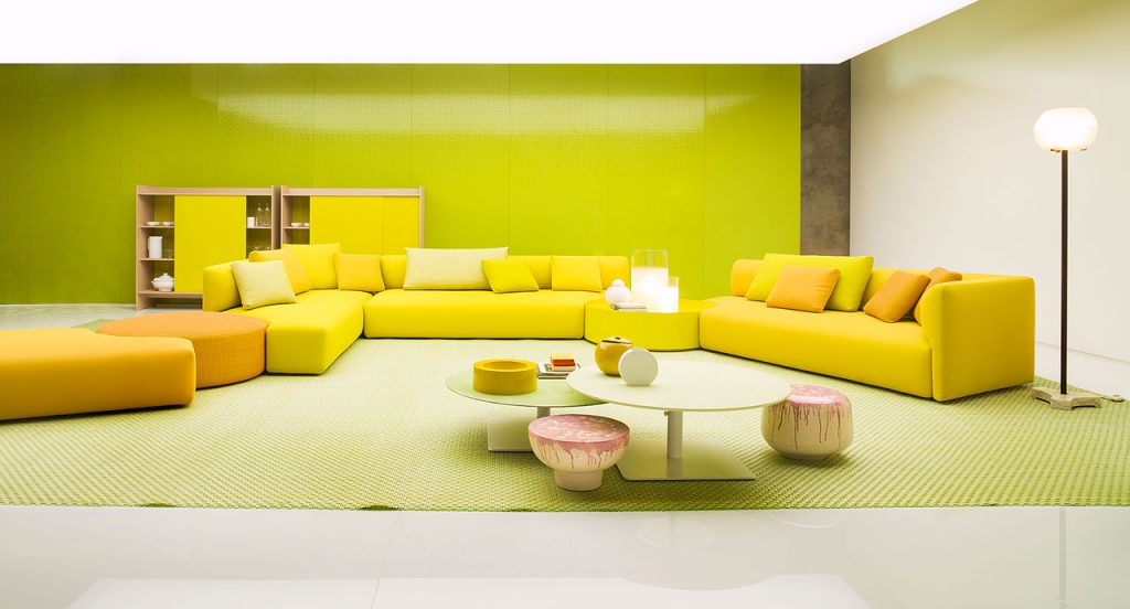 Three yellow Walt Sofas of three seats with high back in a living room.