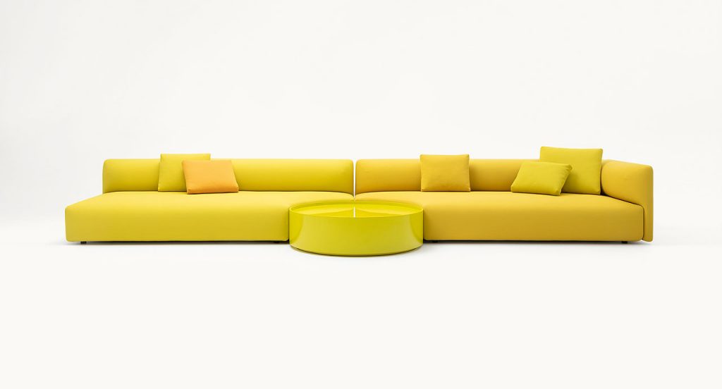 Two yellow Walt Sofas of three seats with high back on a white background.