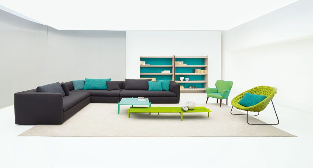 Three grey Walt Sofas of three seats with high back in a living room.