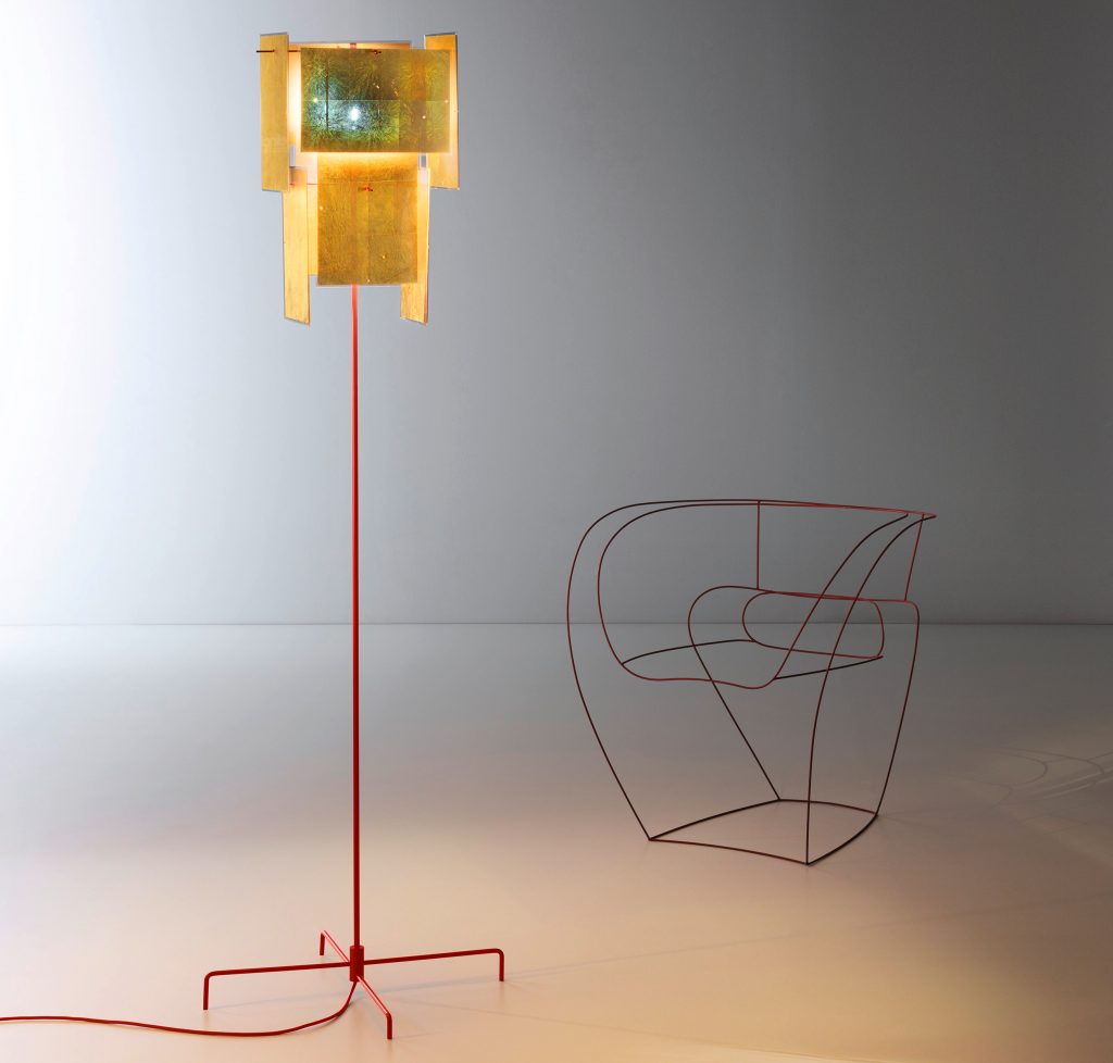 A 24 Karat Floor lamp standing on top of a white floor