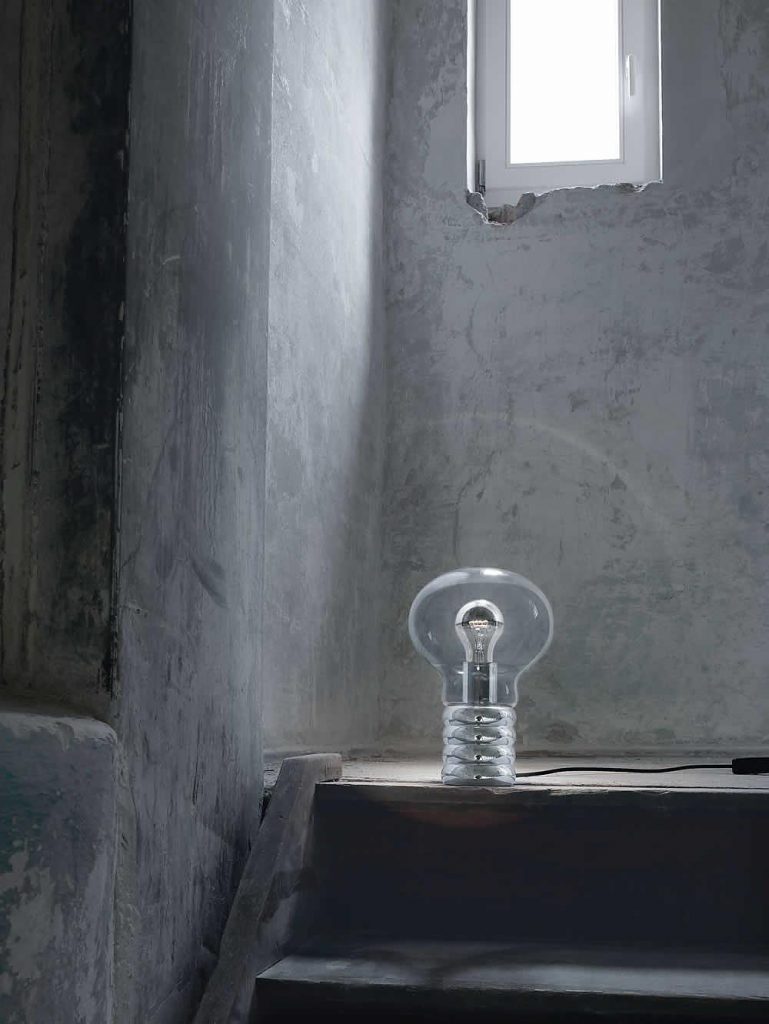 Bulb on a table next to a bed