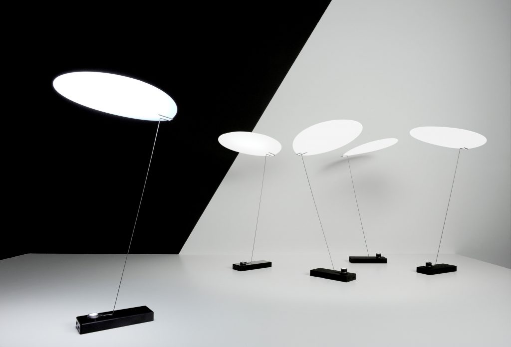 Five Koyoo illuminated standing in front of a black and white background