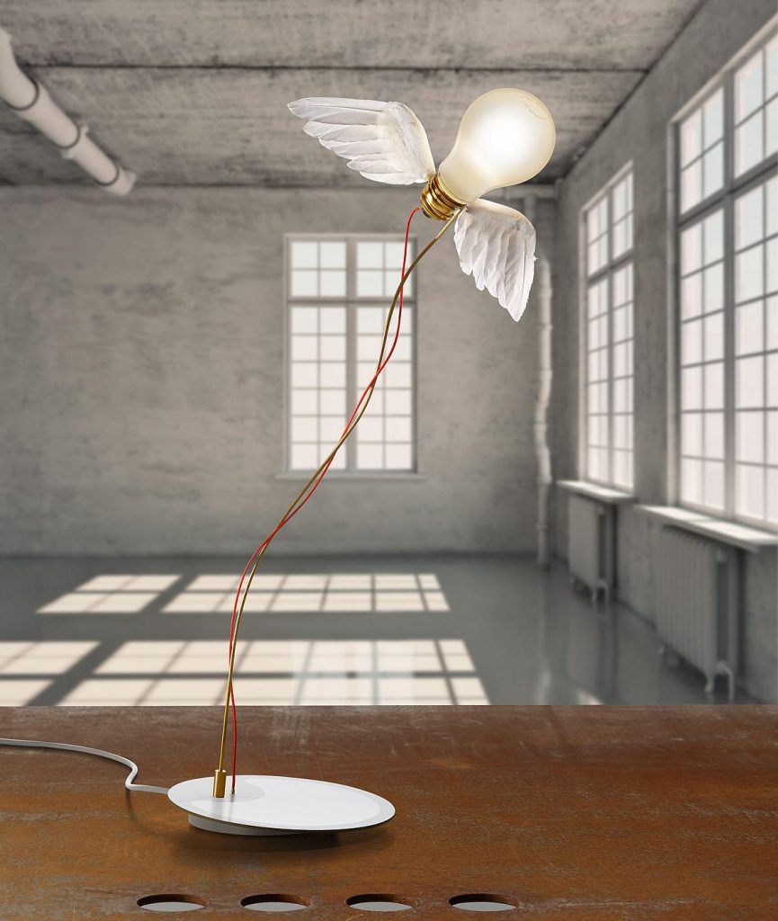 A Lucellino light on a wooden table with a sunny windowed background