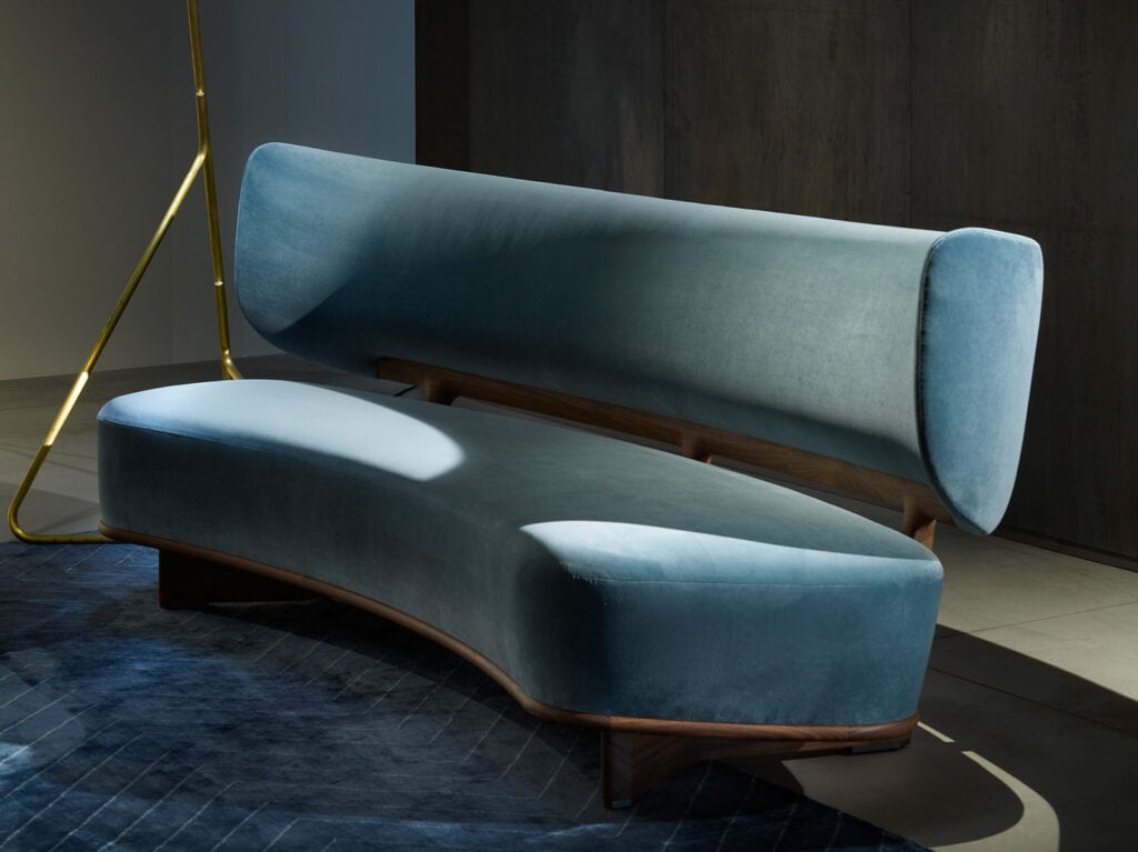 large cushion made of blue-colored fabric and resting on brown-colored wood in a living room