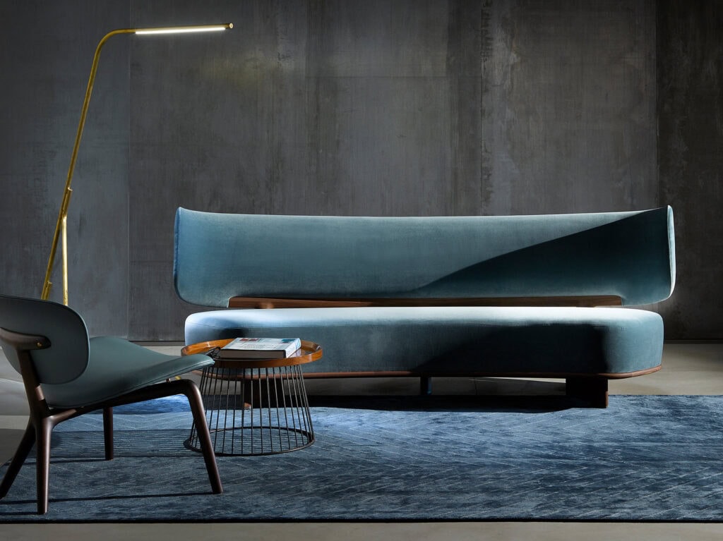 large cushion made of blue-colored fabric and resting on brown-colored wood in a living room