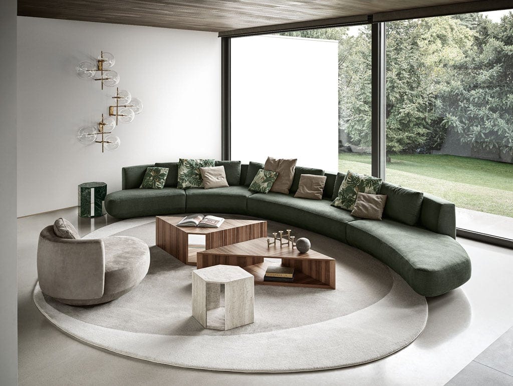 large modular sofa made of internal wood lined with foam and upholstered in fabric or leather in a green tone