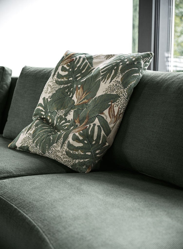 large modular sofa made of internal wood lined with foam and upholstered in fabric or leather in a green tone