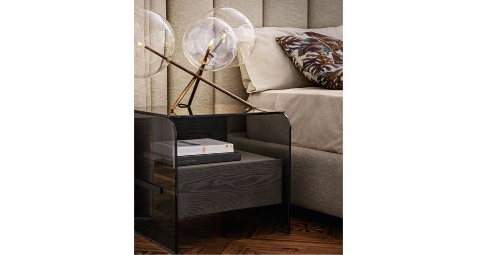 nightstand made with a drawer structure in lacquered ash, top and sides in smoked glass in a powder gray tone in a room