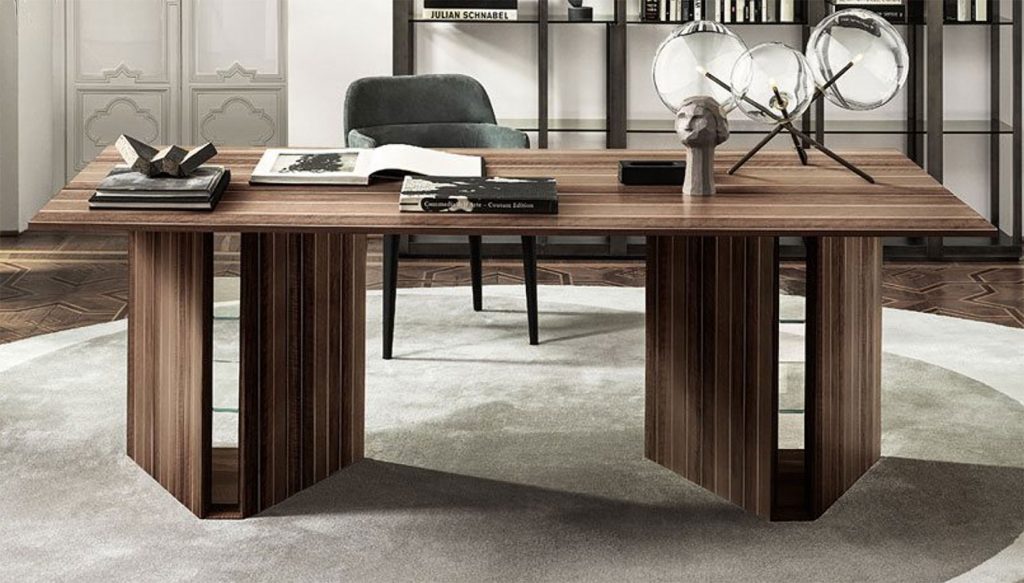 Indian Rosewood desk lined with natural aluminum on a wooden base in a brown tone in an office