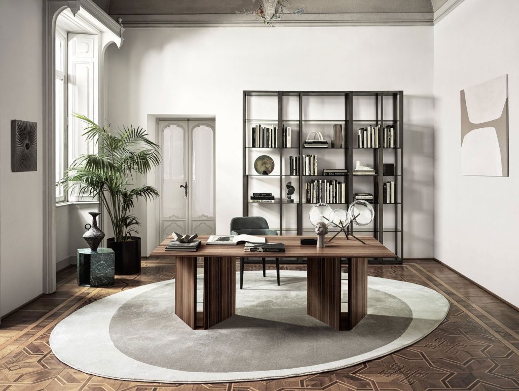 Indian Rosewood desk lined with natural aluminum on a wooden base in a brown tone in an office