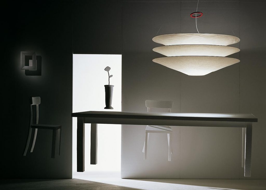 Floatation light hanging over a table with light coming through the doorway