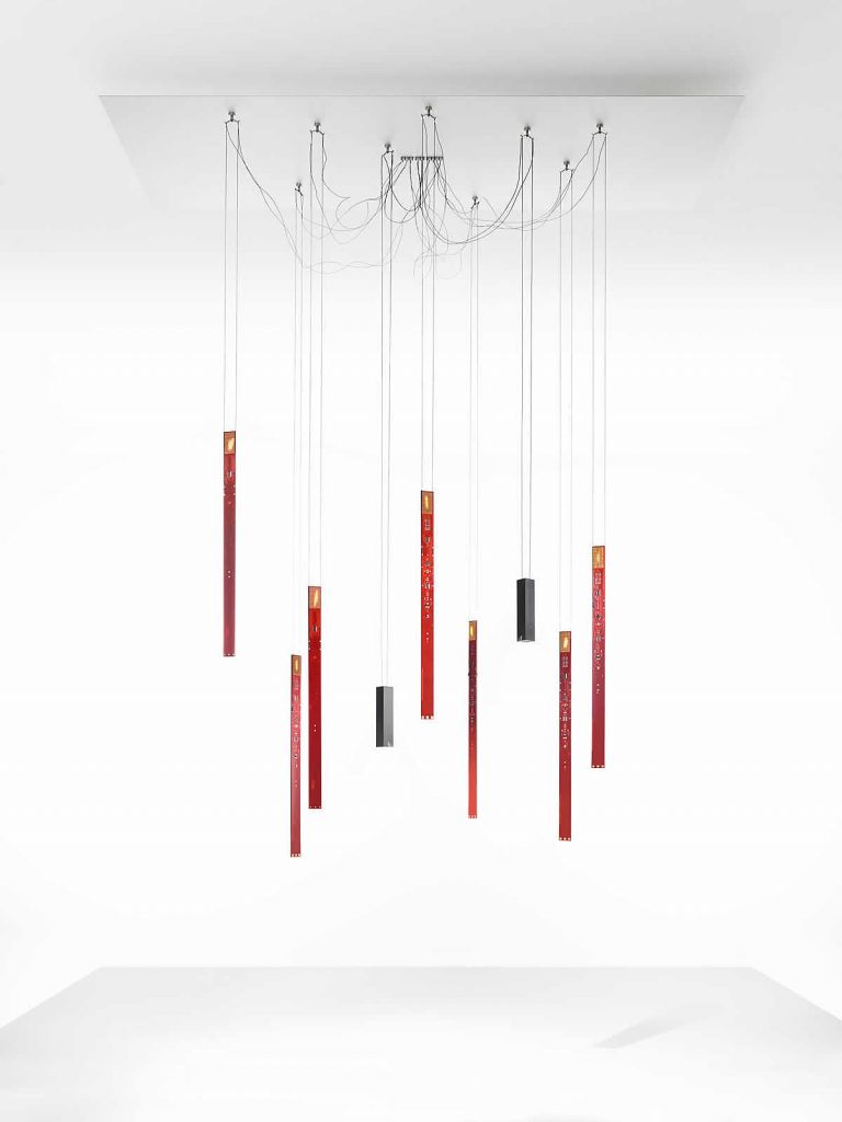 A group of red and black Flying Flames hanging from a ceiling in front of a white background