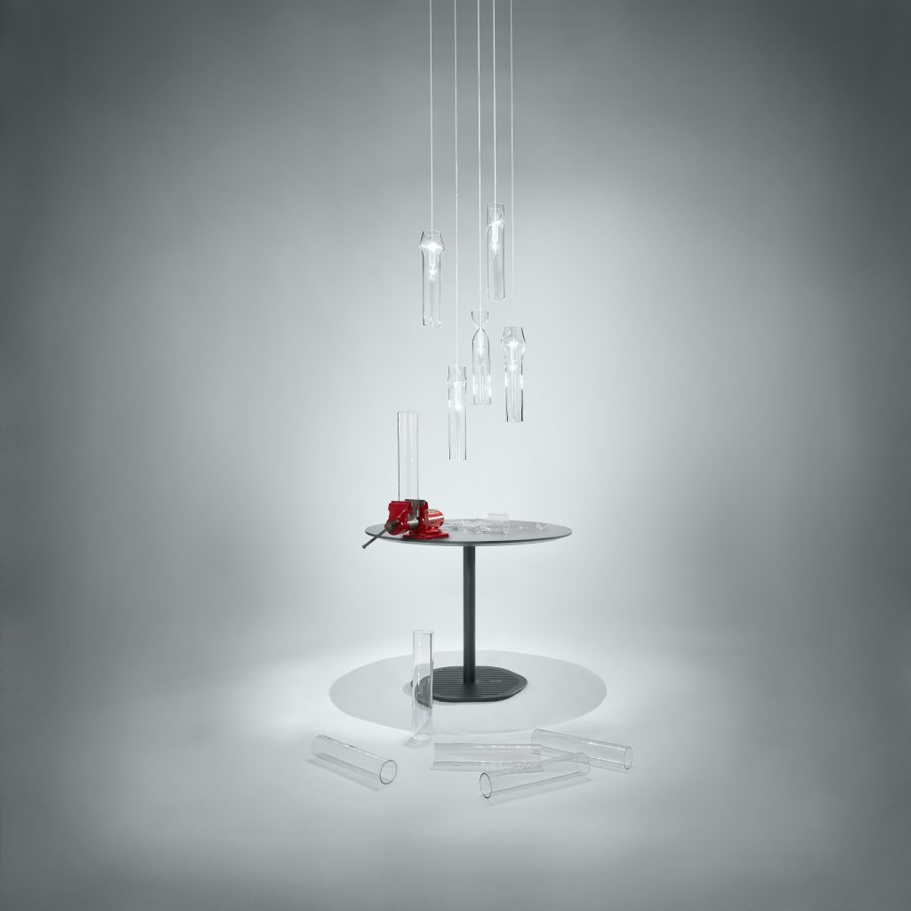 Unique shaped lamp made of bohemian glass base with steel base on a gray background