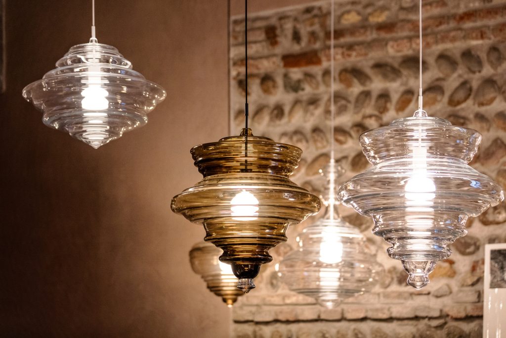 four lamps made from blown glass in a transparent brown tone in a living room