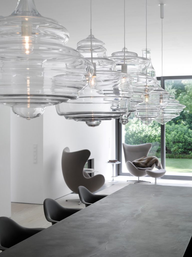 four lamps made from blown glass in a transparent tone in a living room