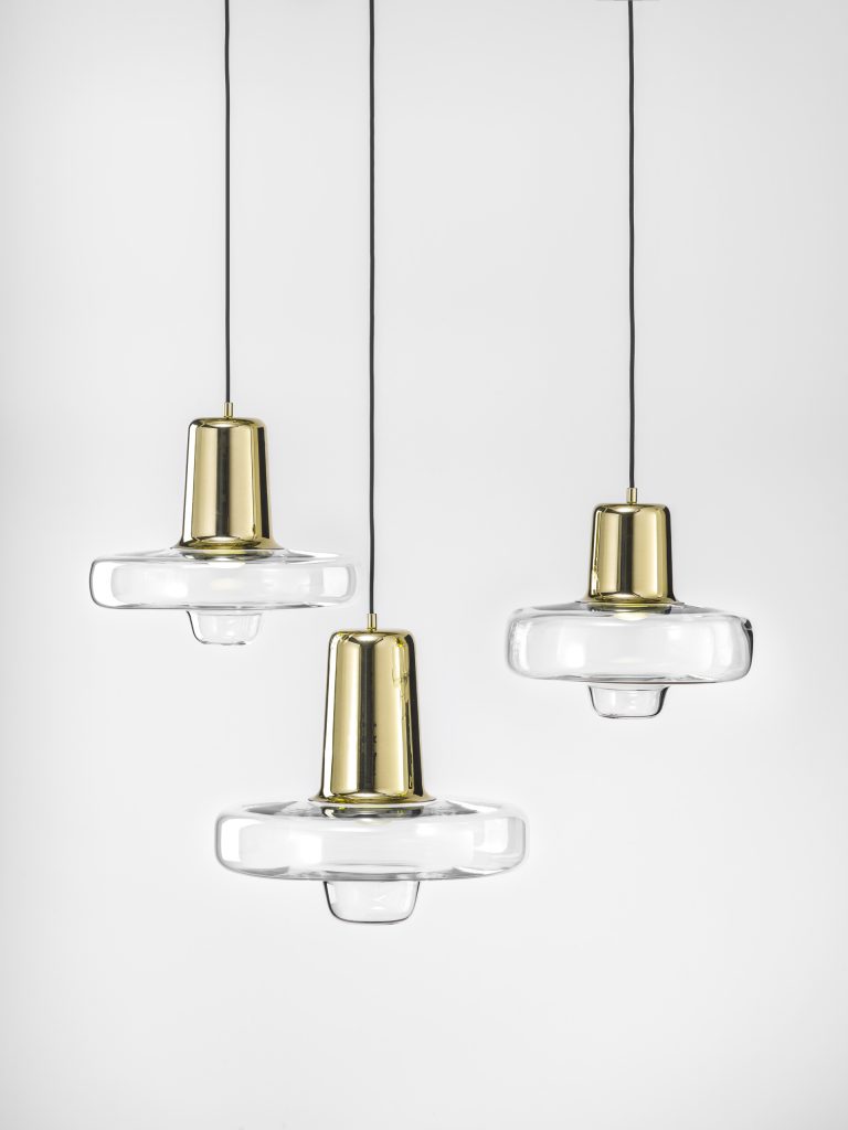 Three smalls pendants made of bohemian glass with a steel base in a gold tone on a white background