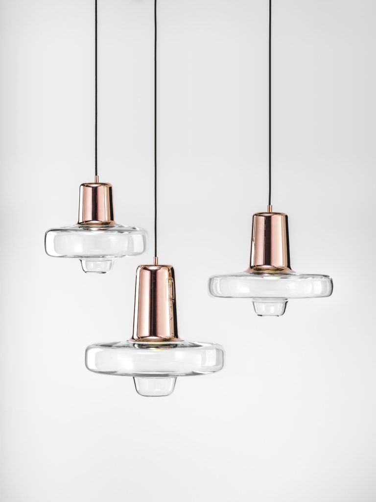 Three smalls pendants made of bohemian glass with a steel base in a bronze tone on a white background