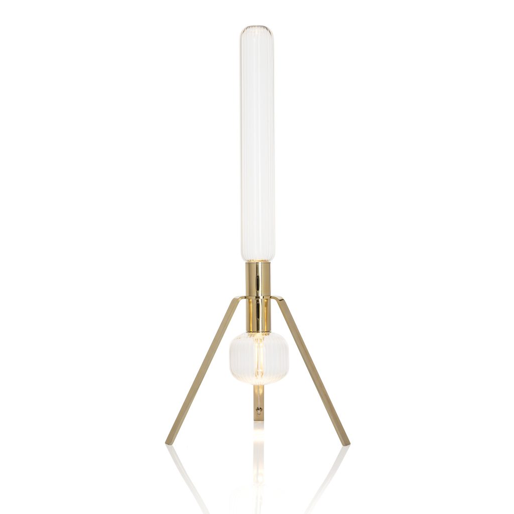 long lamp made of tripod-shaped golden steel base and bohemian glass panels in a white tone on a white background