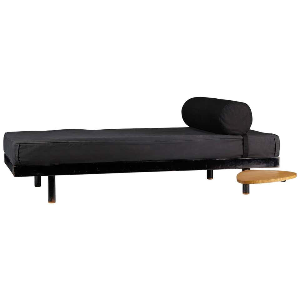 sofa made of metal wood base and upholstered in black leather on a white background
