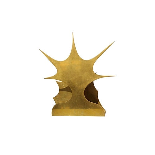 sculpture made of brass in a golden tone in the shape of a sun on a white background