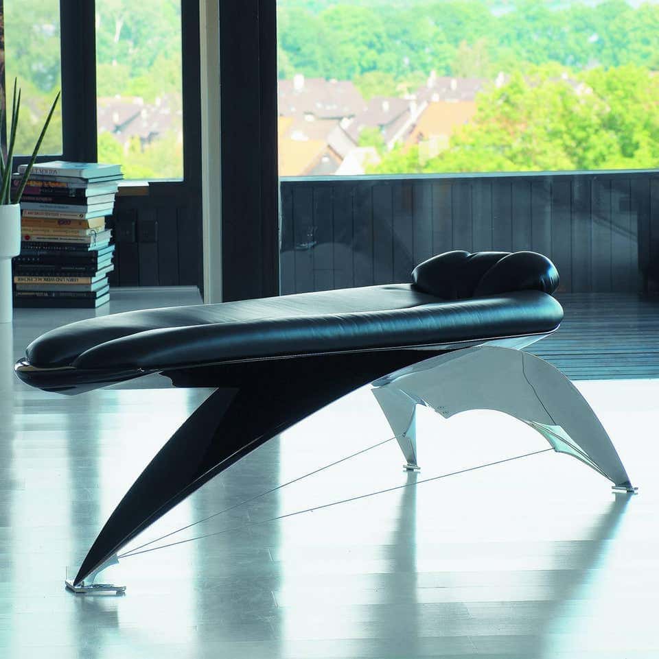 reclining table made of corrugated steel base in a silver tone upholstered in black leather tone on a living room