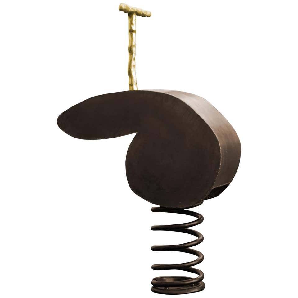 playground sculpture made of wood and a large spring in a brown tone on a white background