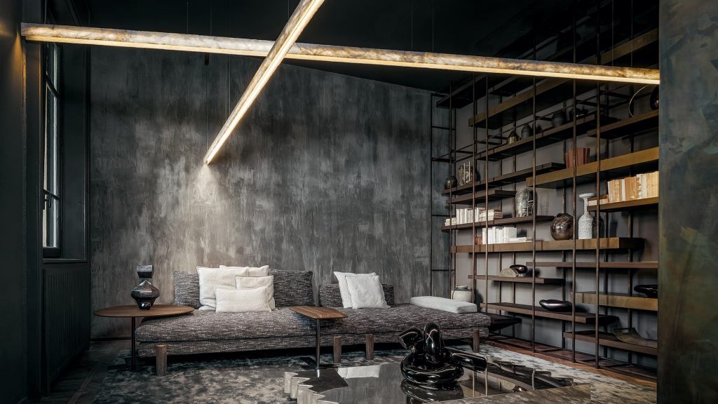 two long lamps made of white glass stone and steel in a gold tone with black in a living room