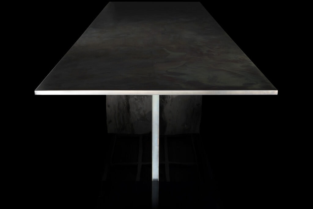 table made of black painted steel base and 20cm top in titanium stone in a gray tone on a black background