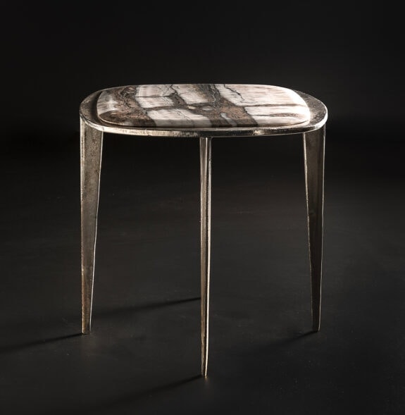 stool made of cast brass base and top set in white stone on a black background