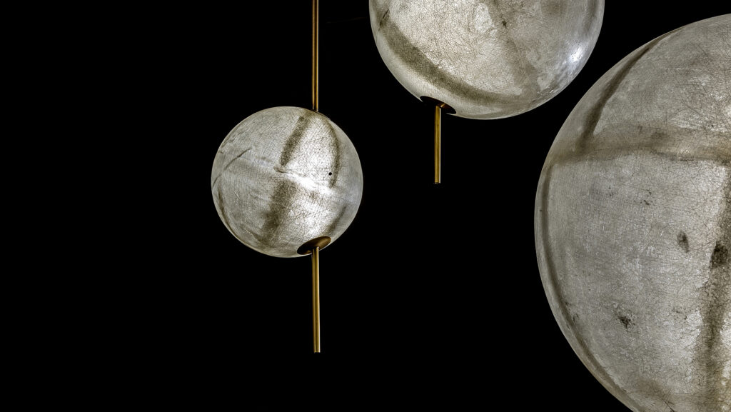 three LED lamps made of fiberglass in a tone of gray with gold