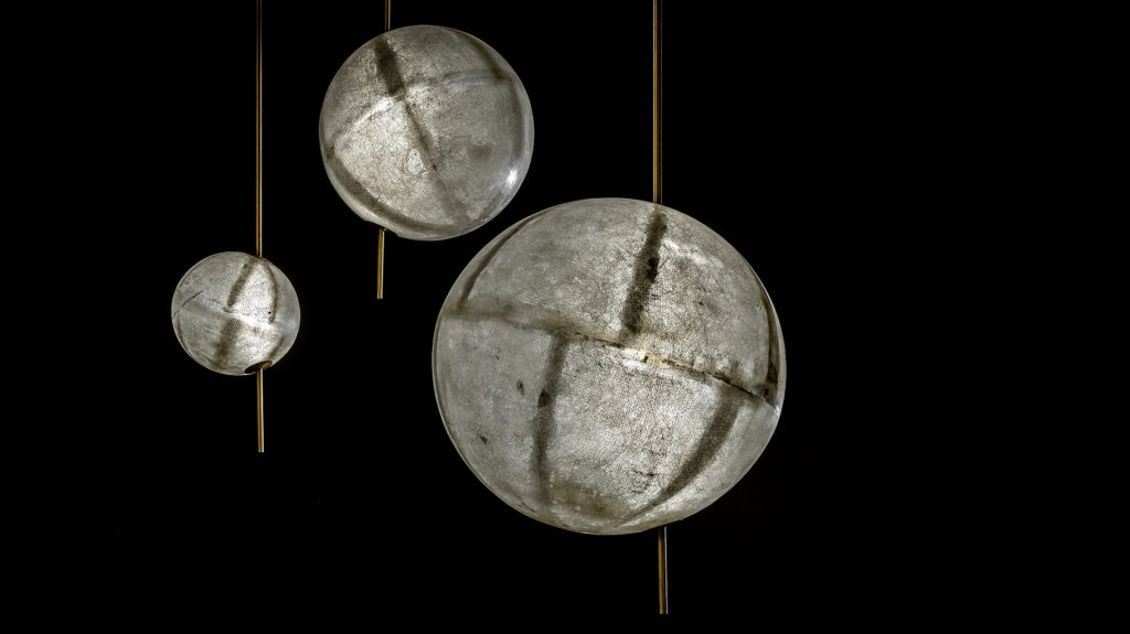 three LED lamps made of fiberglass in a tone of gray with gold