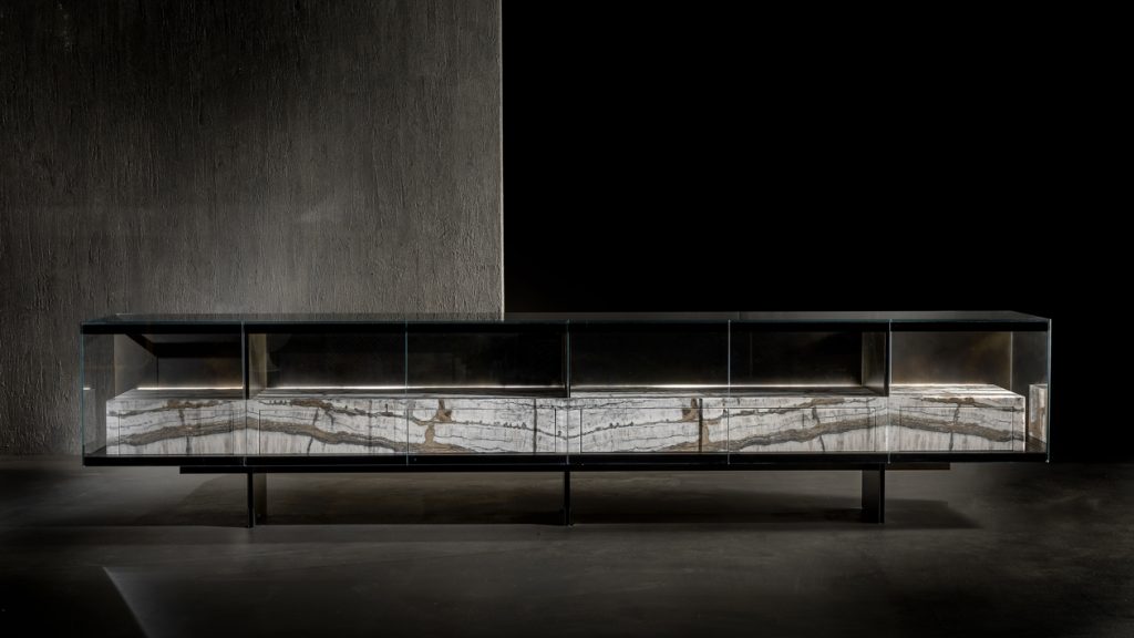 large sideboard made of metal and stone brass base in a black tone with white and beige on a black background
