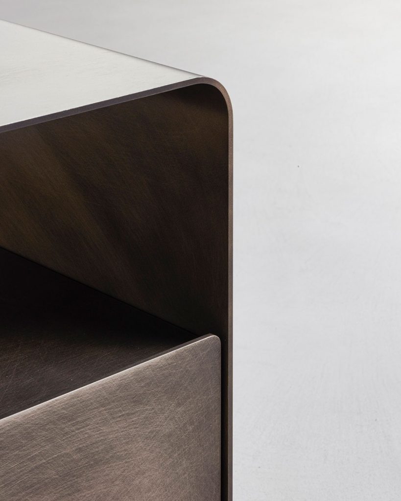 nightstand with compartments in the structure made of burnished brass in a golden tone