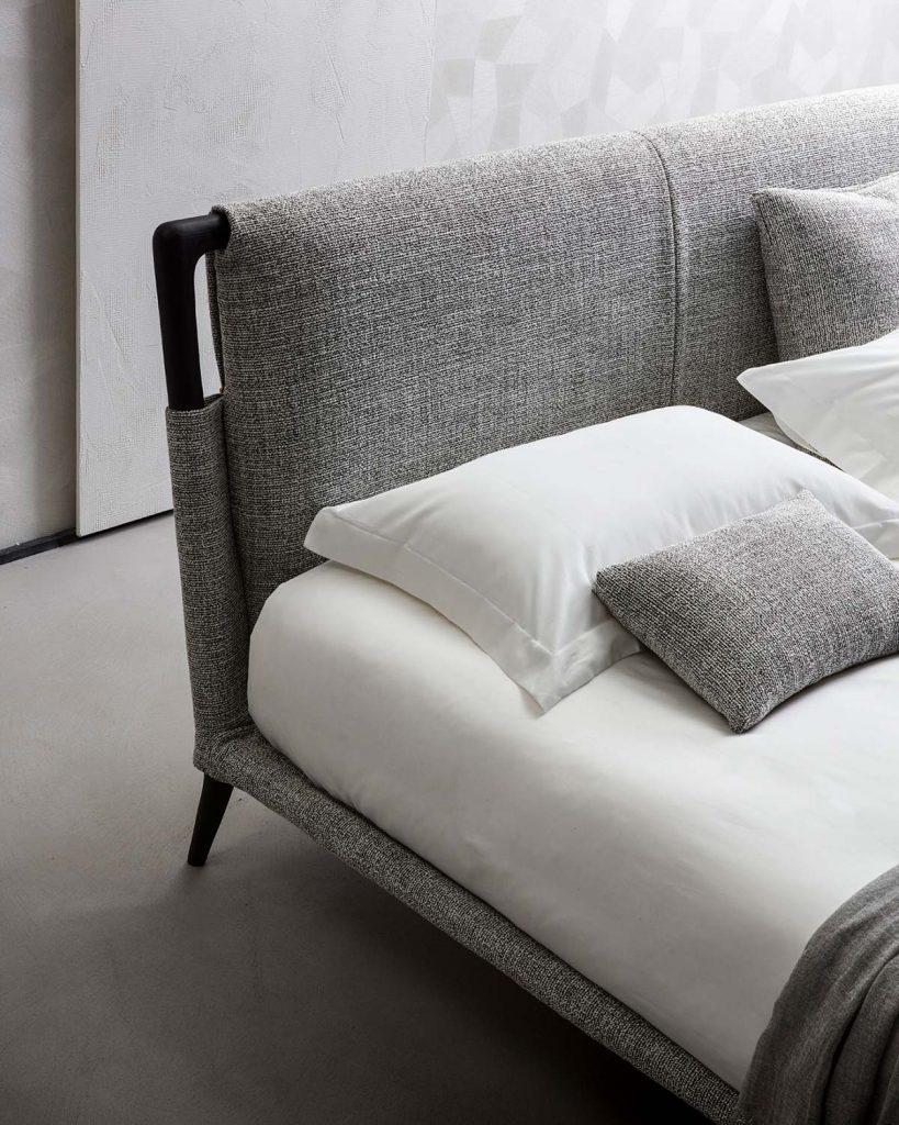 headboard made of wood upholstered in light gray fabric and black wood
