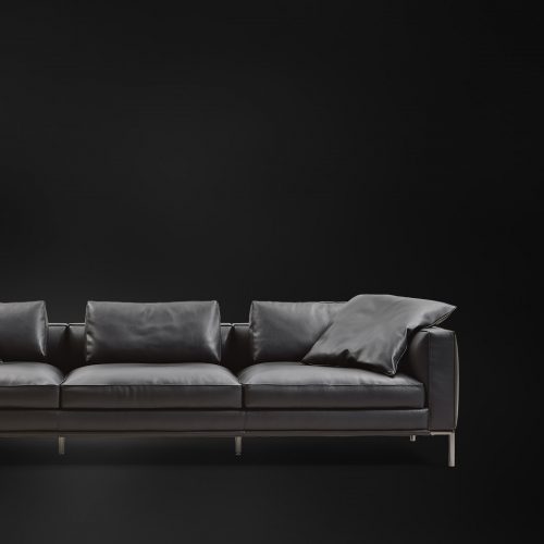 metal base and aluminum feet upholstered in black leather filled with goose down on a black background