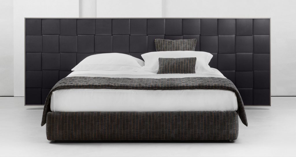 bed with large backrest engraved in macro woven wood pattern and upholstered in black leather on a white background
