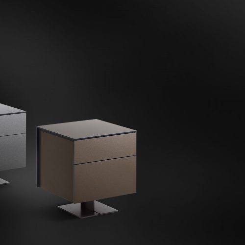 Two nightstand with central curved metal foot and drawers made of lacquered wood in a gray and brown tone on a black background
