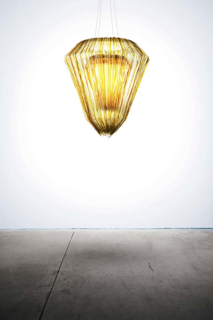 ceiling lamp made in a gold tone in the shape of a diamond with the focus inside on a white background