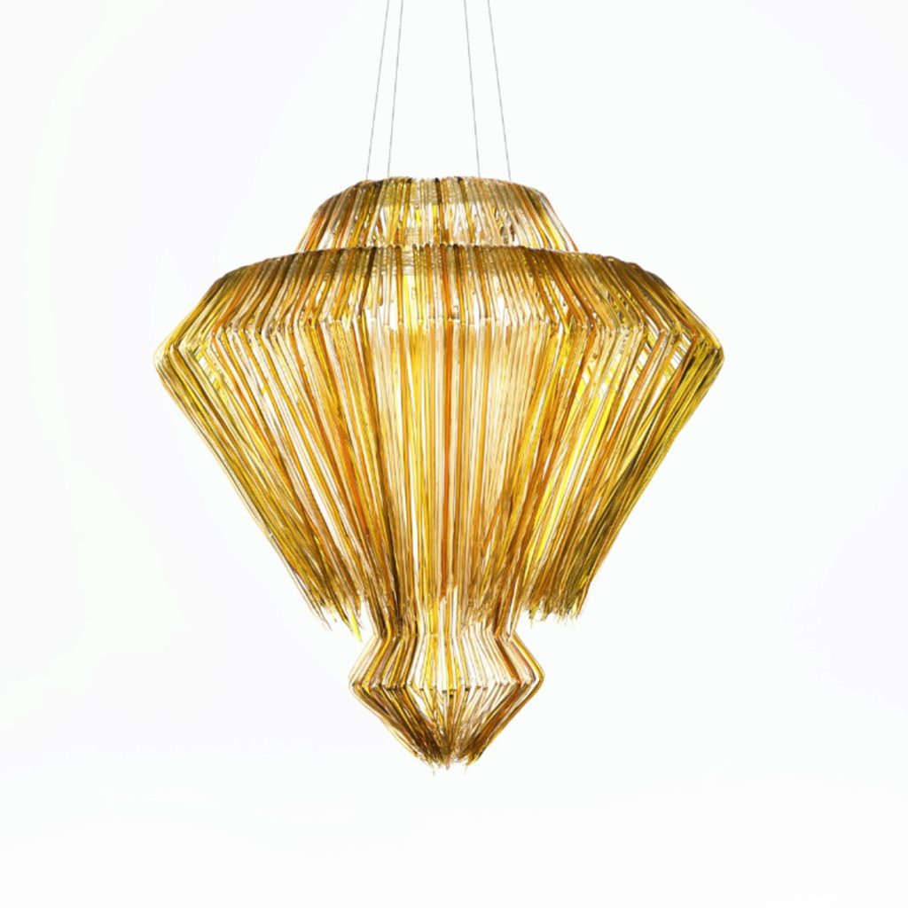 lamp made of several thin vertical strips in a golden color tone on a white background
