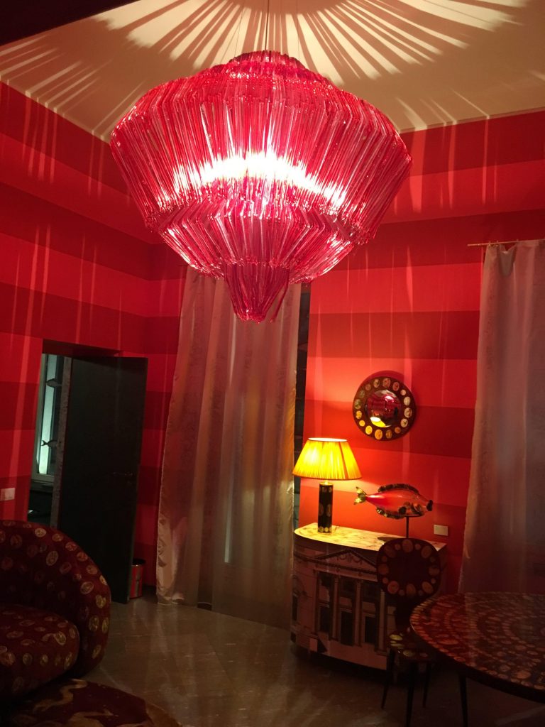 lamp made of several thin vertical strips in a red color tone