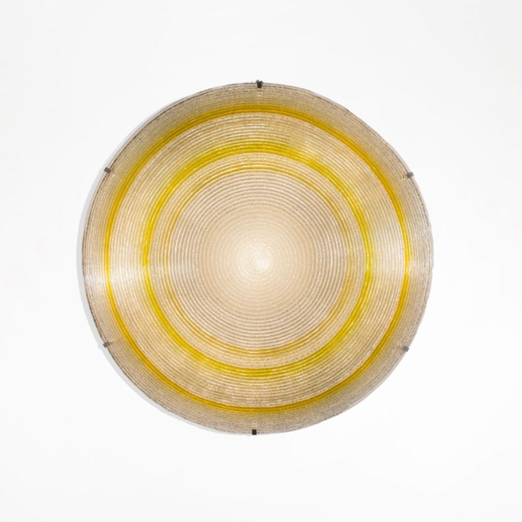 lamp made of methacrylate fused glass made in a sun-shaped design in an golden and silver color tone