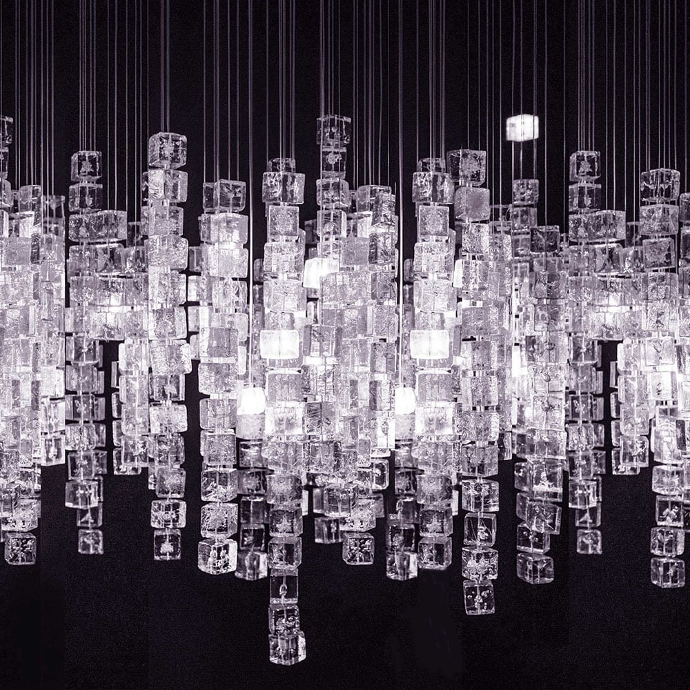 Line of chandeliers made of polycarbonate cubes in a tone white on a white background