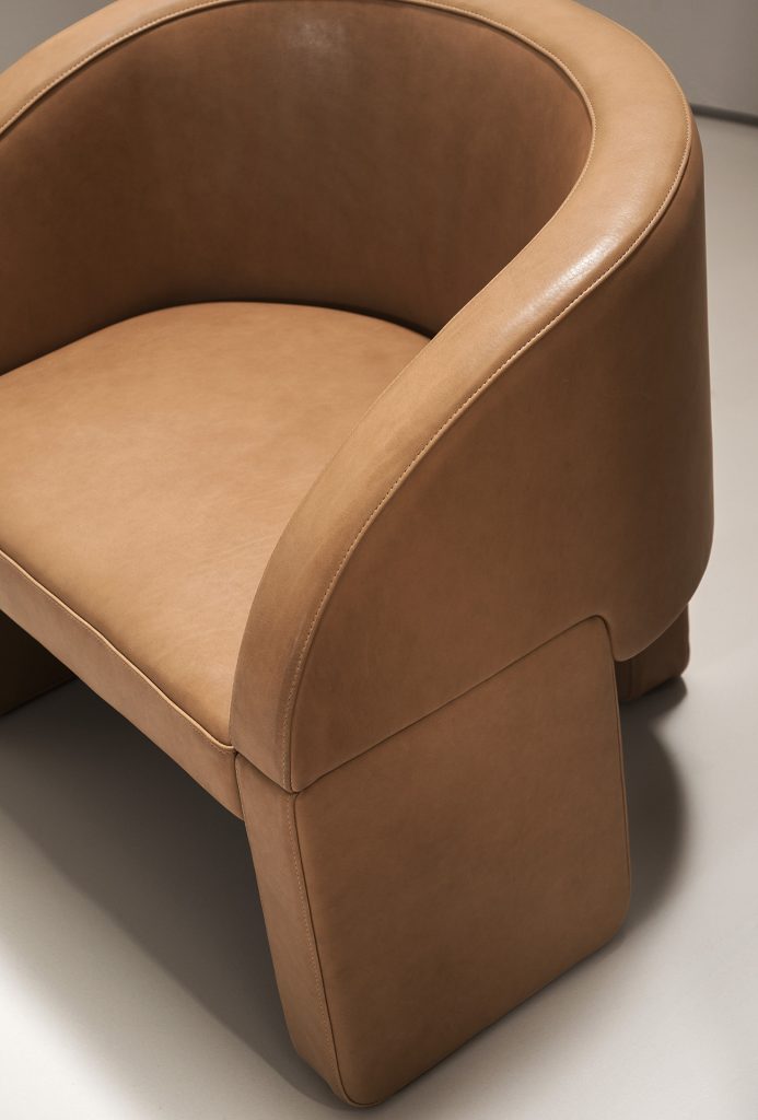 chair made of leather in an orange tone with three legs of supports