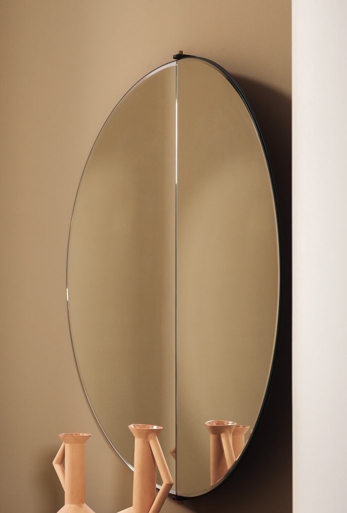 circle-shaped mirror made of glass on top of a piece of furniture