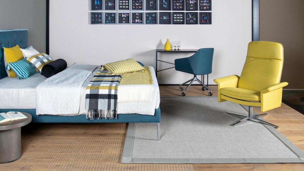 high-back desk chair covered in leather in a yellow tone in a room