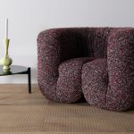 armchair made of textile fabric in a purple tone with white finishes in a living room