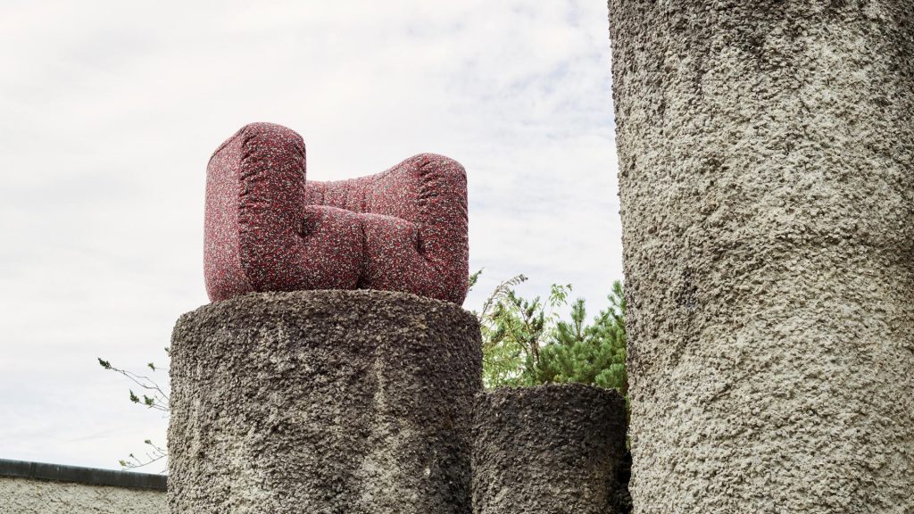 armchair made of textile fabric in a purple tone with white finishes