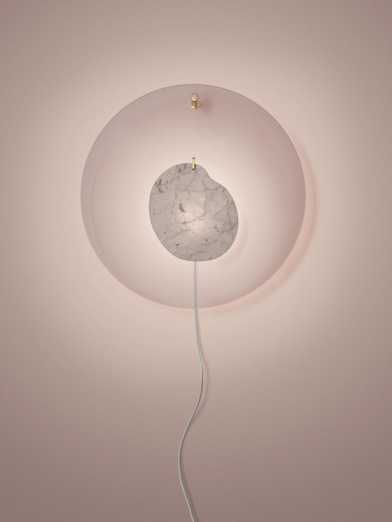 ceiling lamp made of marble and transparent disc in a pink and gray tone on a pink background